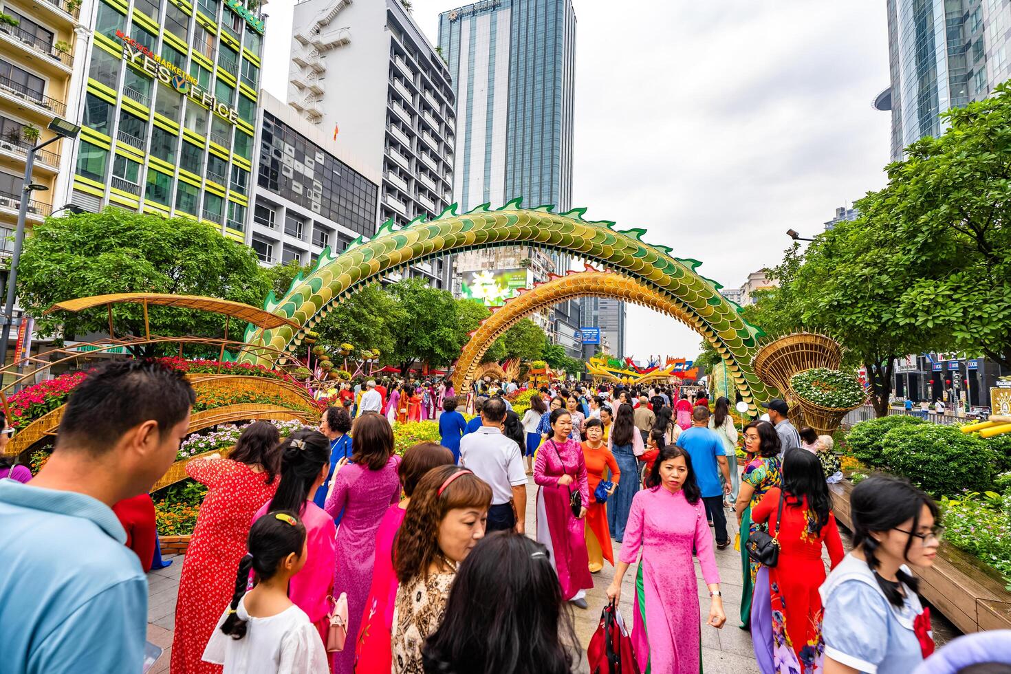 Walking street morning Lunar New Year at downtown with flowers decorated along street attract many tourists to visit, in Ho Chi Minh City, Vietnam photo