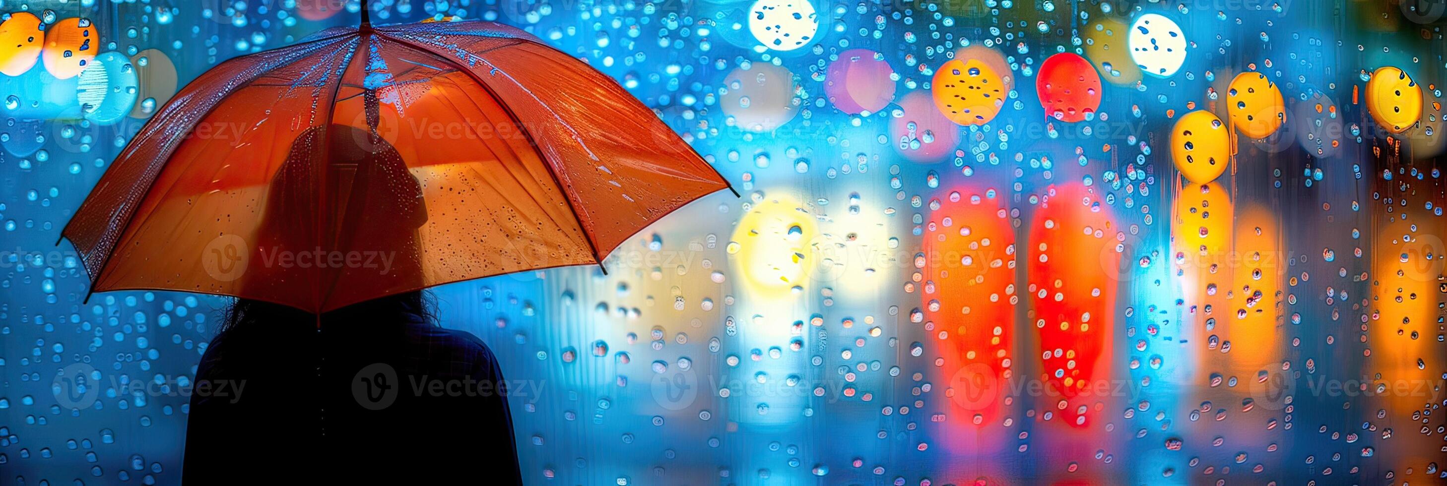 A person is standing in the rain with an umbrella photo