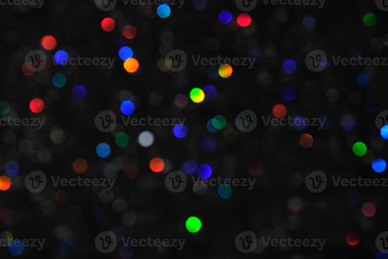 Abstract black background with bokeh of different colors. photo