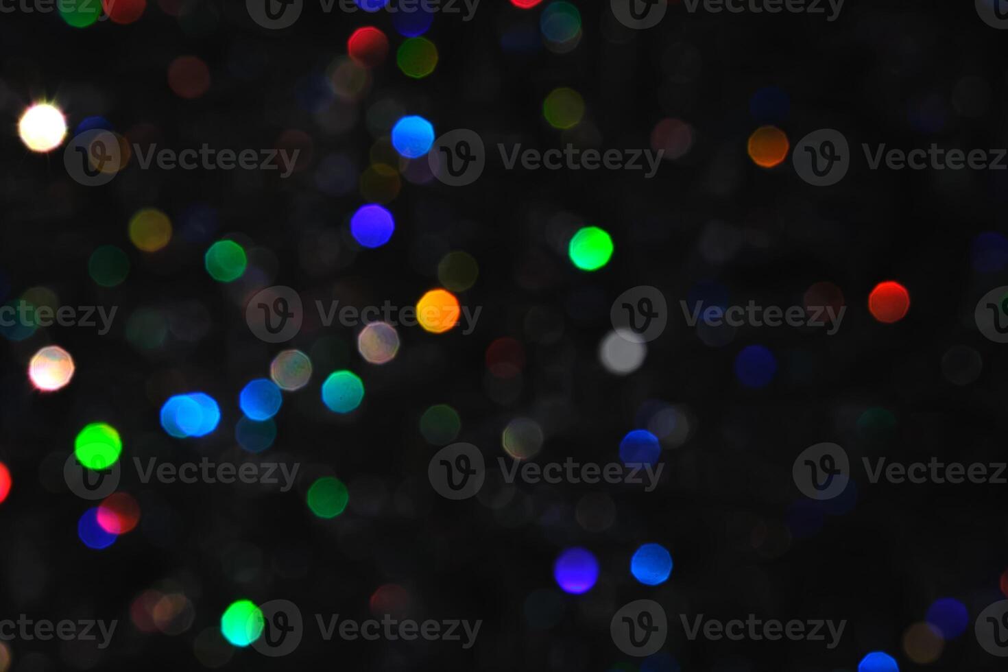 Abstract black background with bokeh of different colors. photo