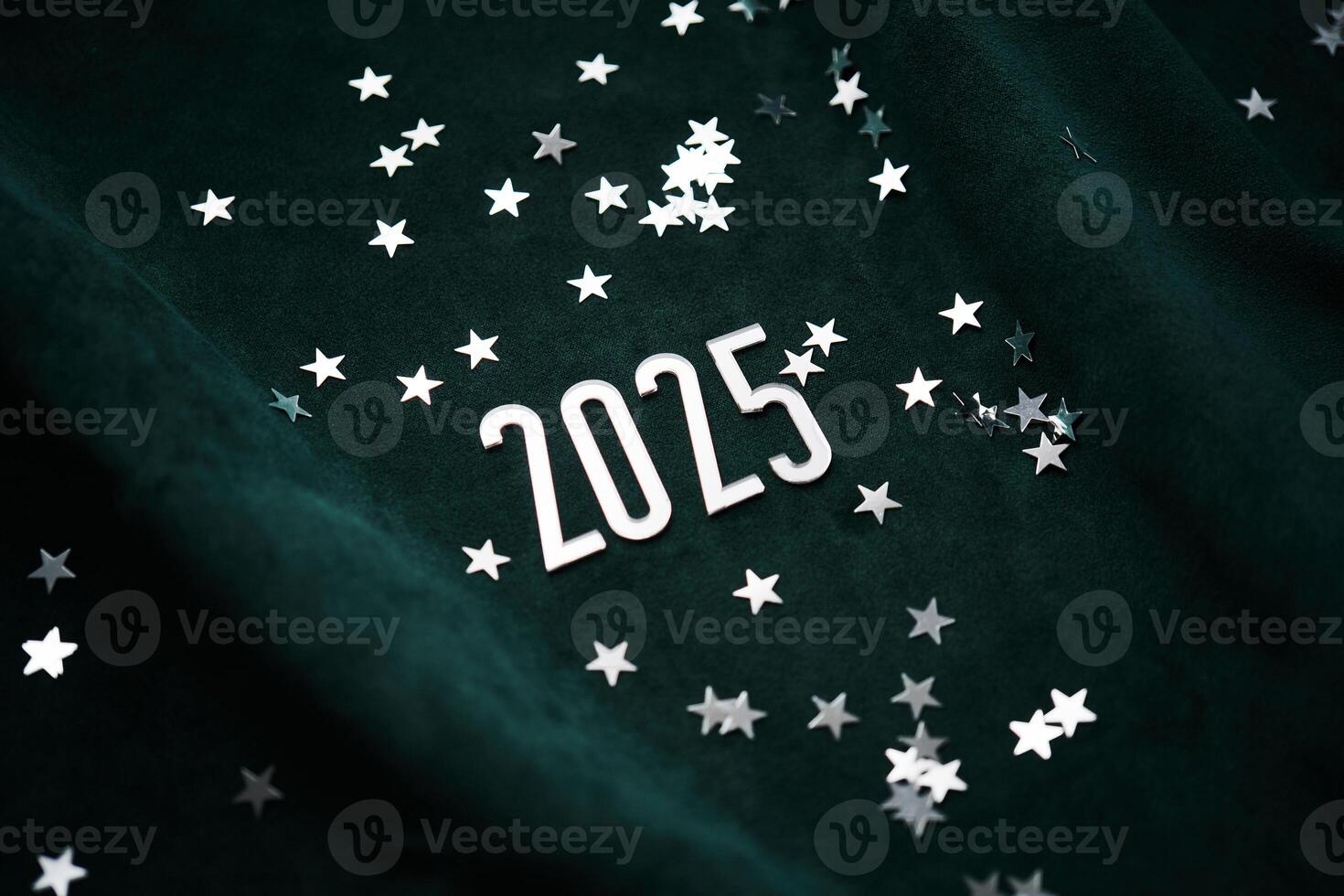New Year's background made of green velvet with silver stars and the number of the year 2025. photo