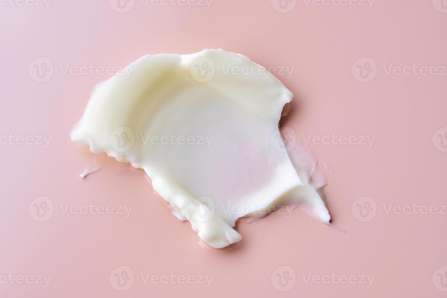 Texture of cosmetic butter on a pink background. Showcasing a thick and nourishing texture. photo