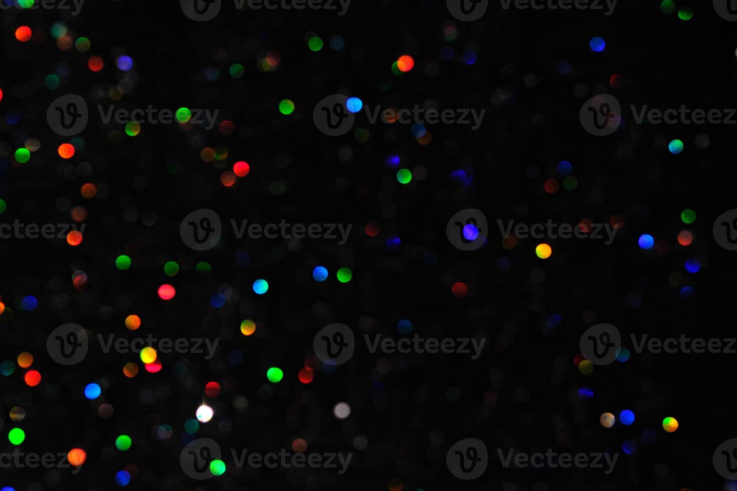 Abstract black background with bokeh of different colors. photo