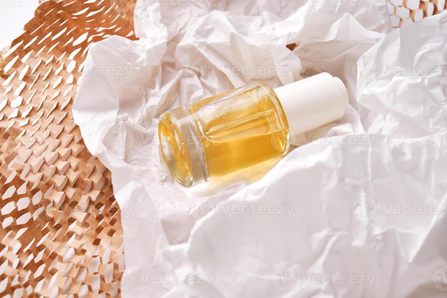 Bottle with yellow serum on paper from the parcel. photo