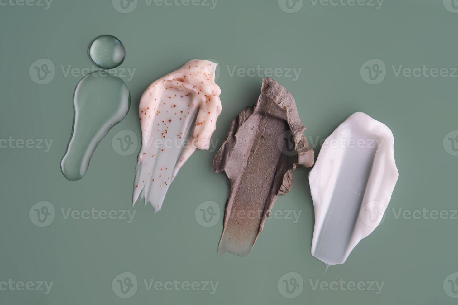 Textures of different cosmetic products on a green background. photo