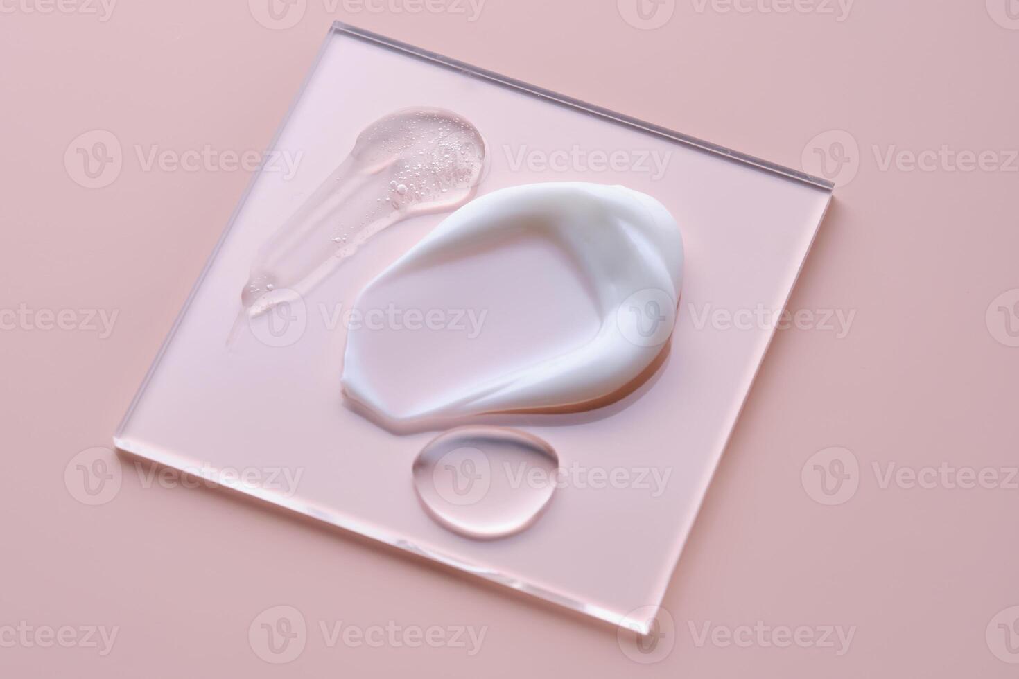 Textures of different cosmetic products on a pink background on a square transparent stand. photo