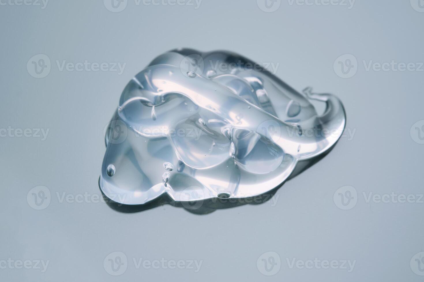 Texture of cosmetic hyaluronic gel or gel lubricant on a green background. photo