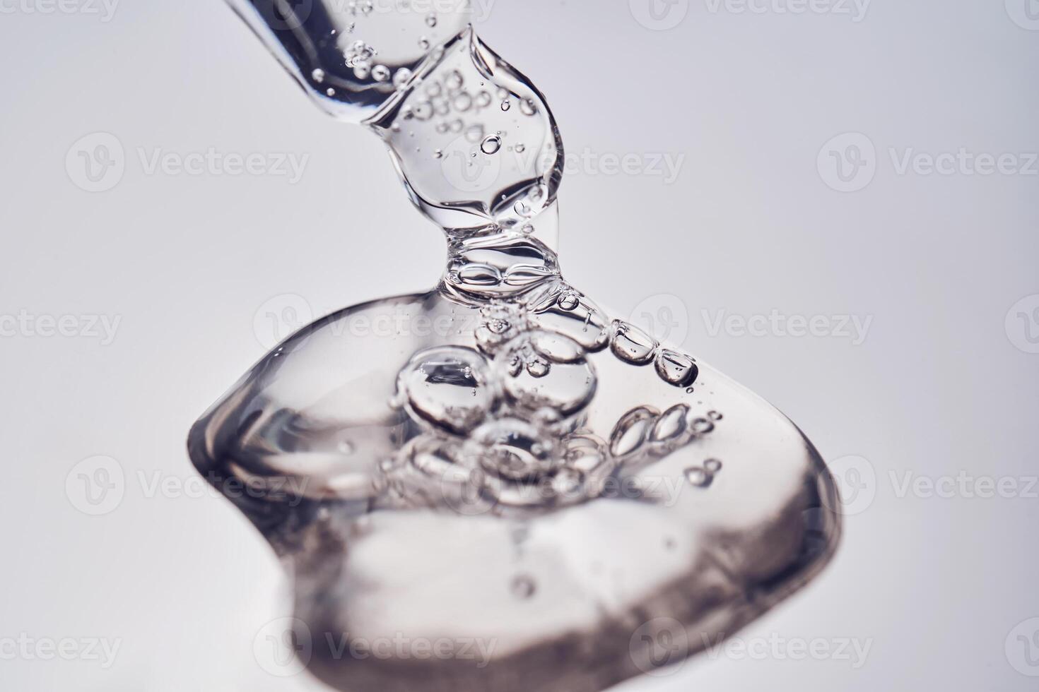 Pipette with cosmetic gel or serum close-up. photo