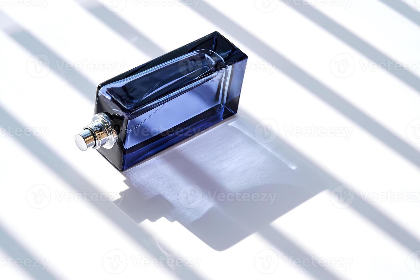 Perfume spray in a blue bottle on a white background. photo