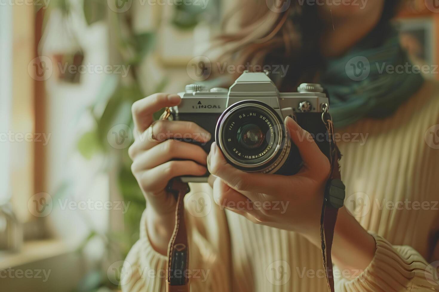 A person holds a vintage camera indoors photo