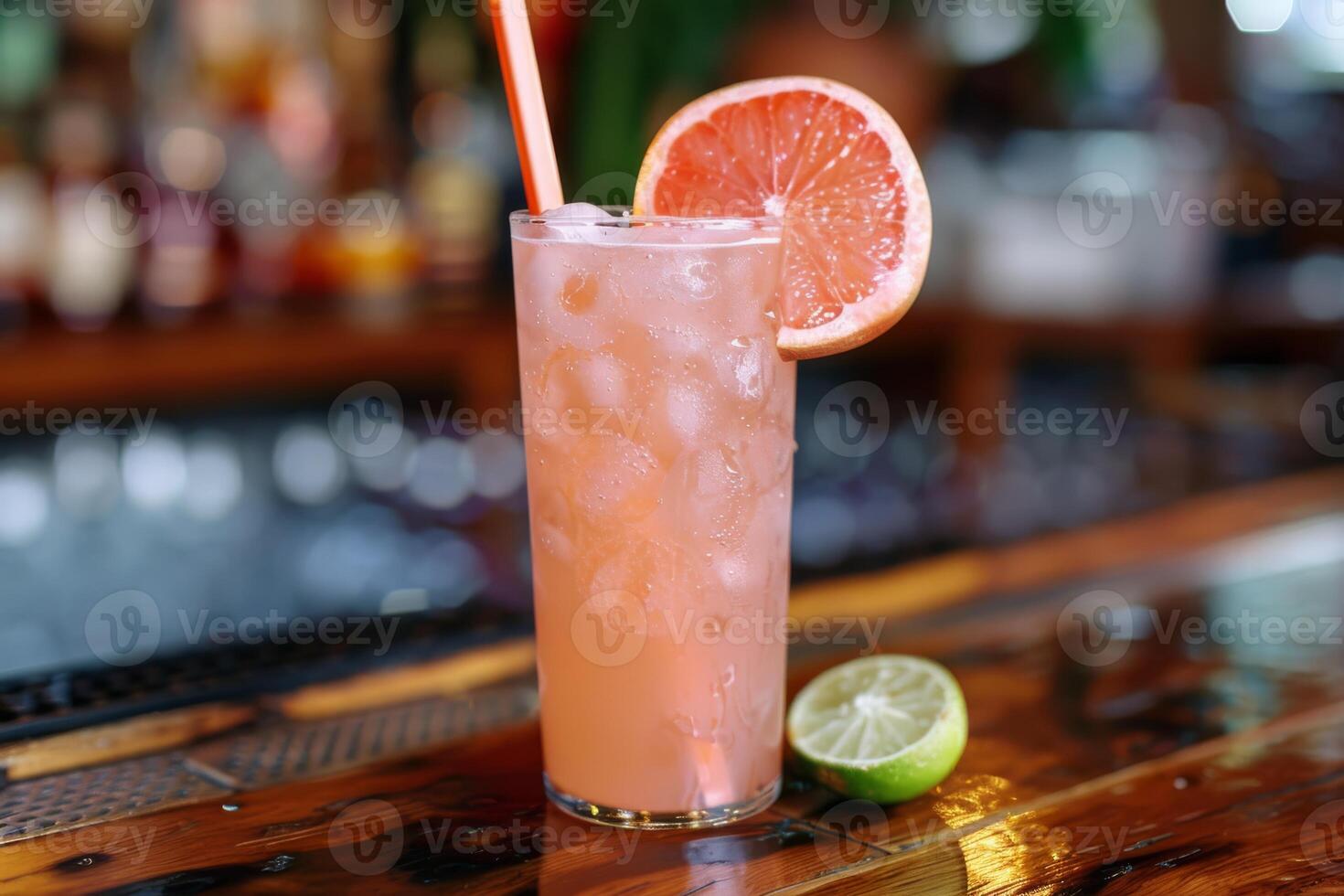 Enjoy the chic ambiance of a retro bar while savoring a pink grapefruit cocktail, a refreshing blend of ice, lime, and tropical flavors. Embrace the elegant setting and celebrate in style photo