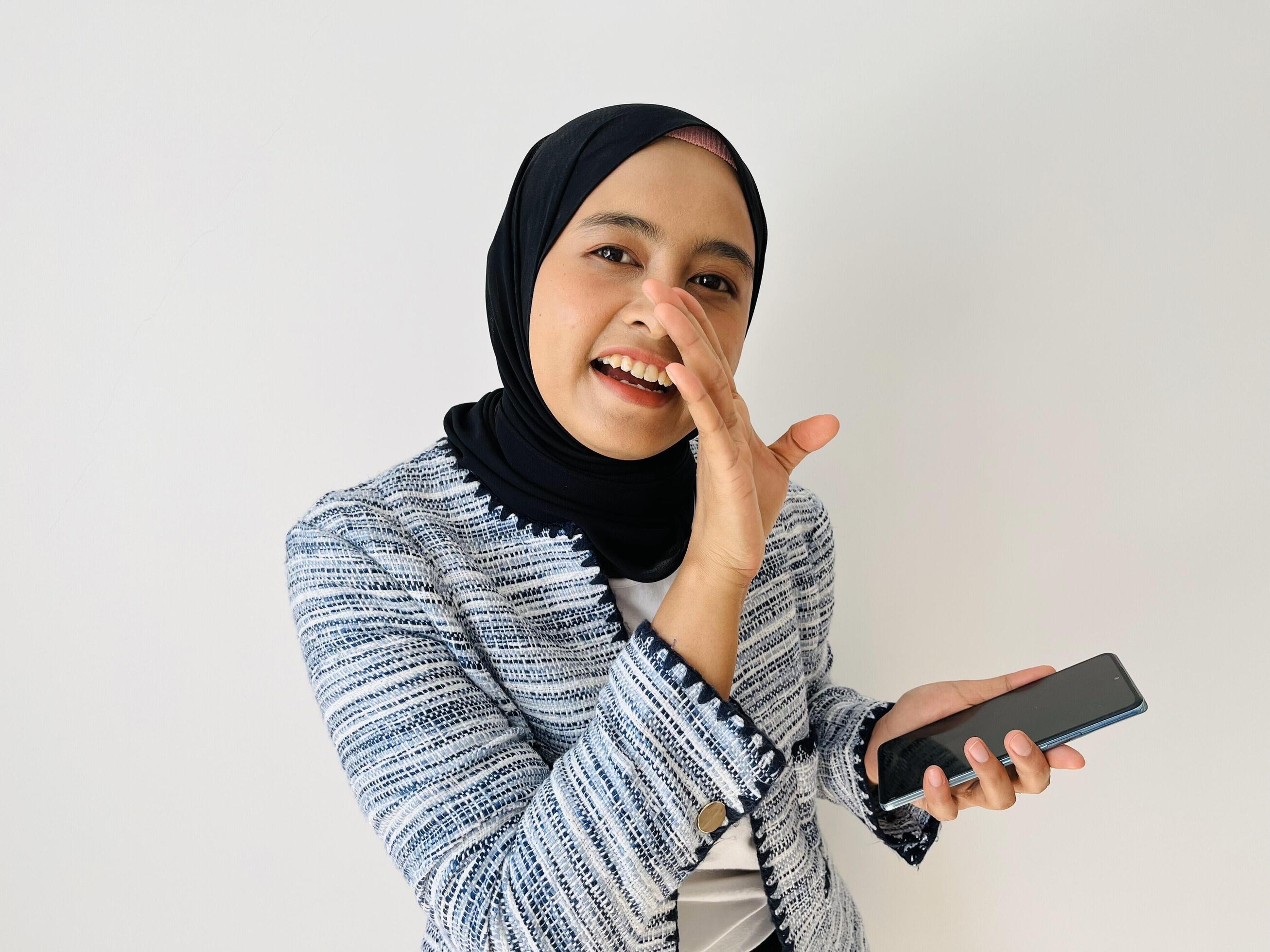 Surprised happy beautiful Asian woman hijab woman act like a telling