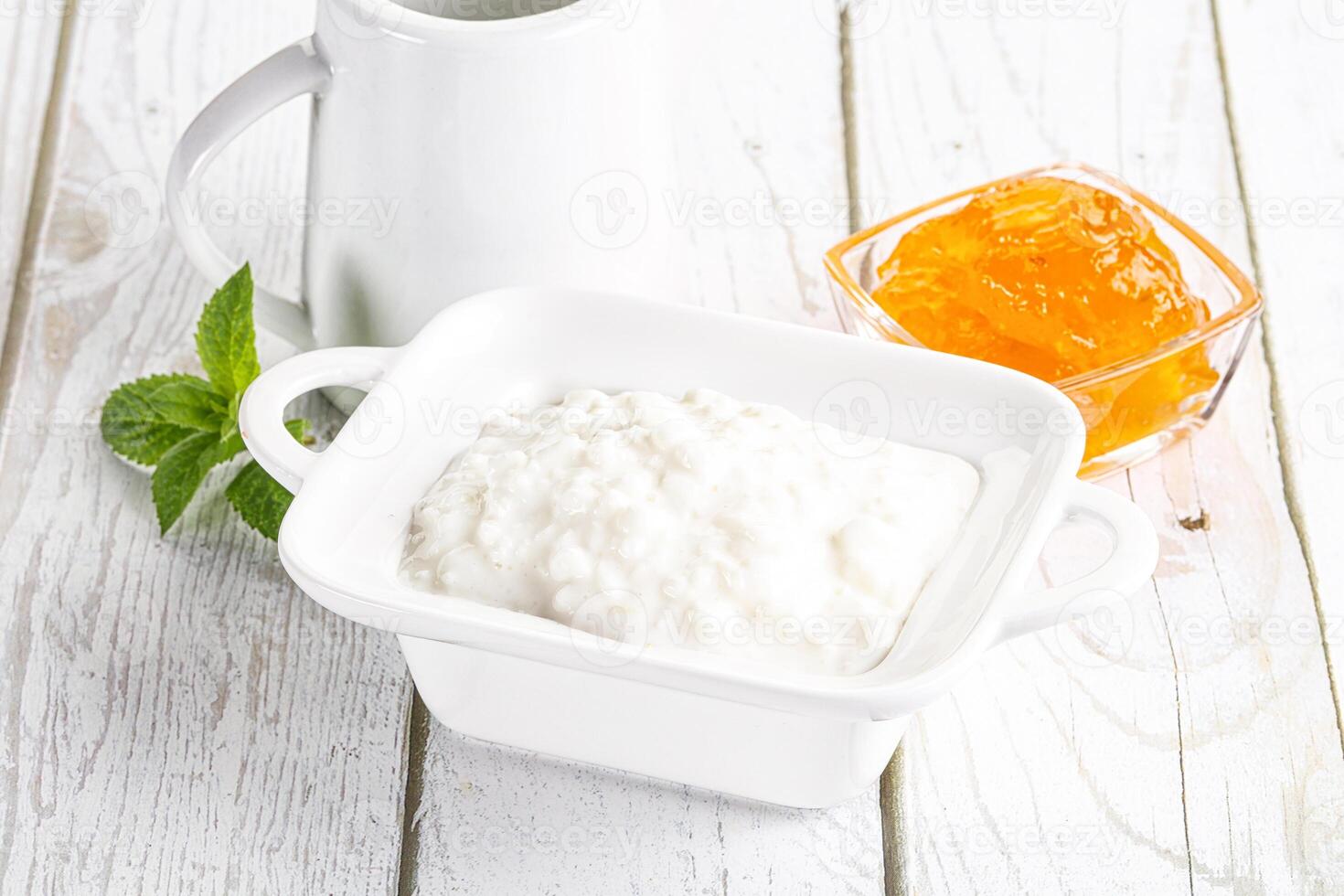 Grain curd with cream and jam photo