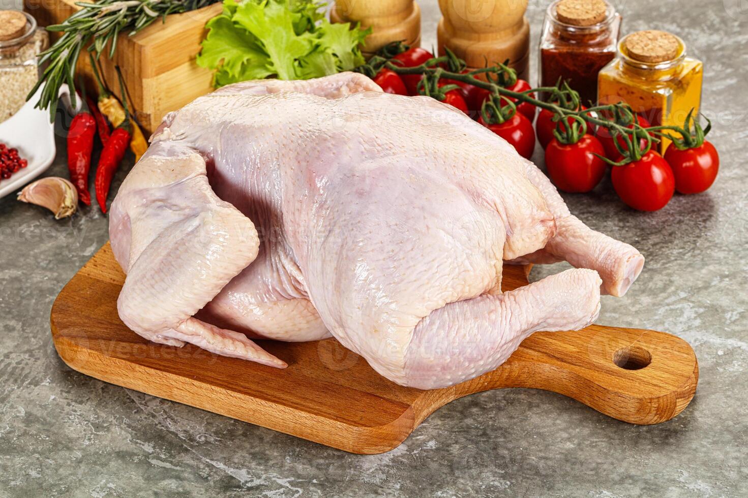 Raw whole chicken for cooking photo