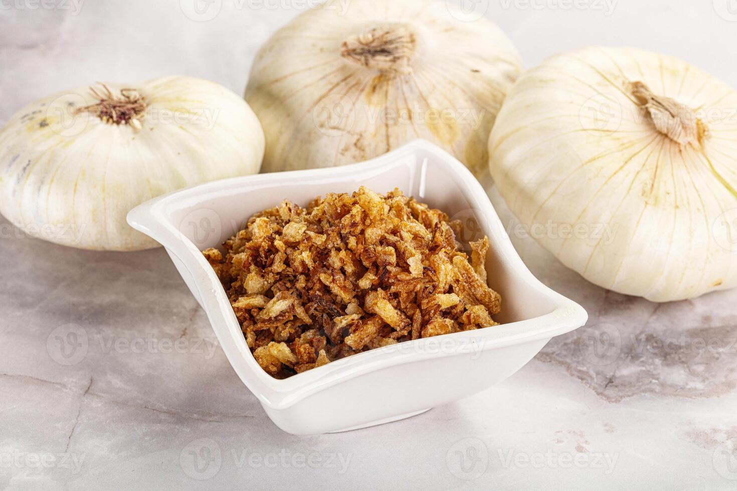 Dried roasted onion flakes for culinary photo