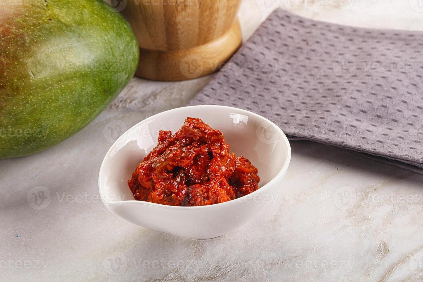 Spicy pickled raw green mango photo