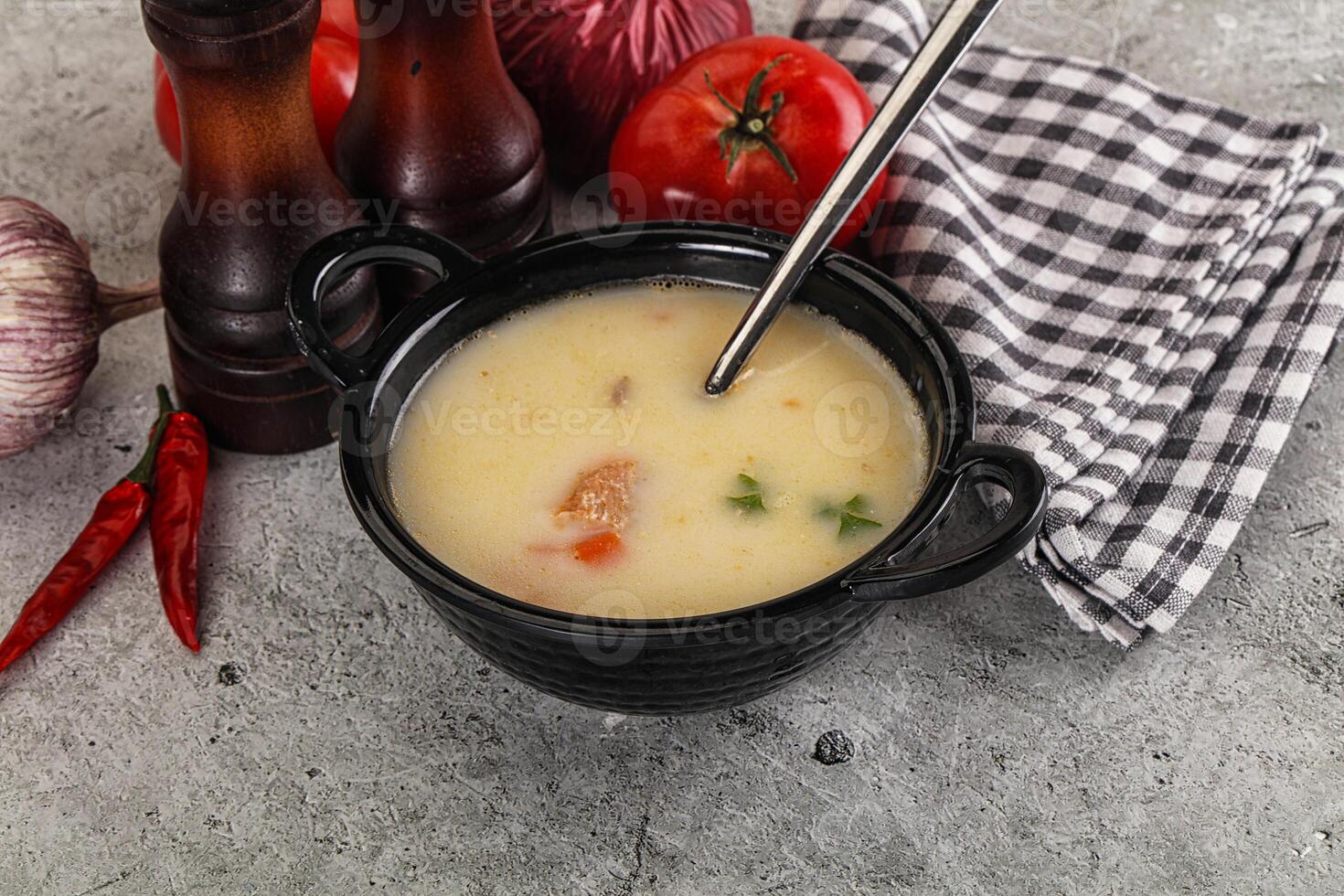 Salmon cream soup with vegetables photo
