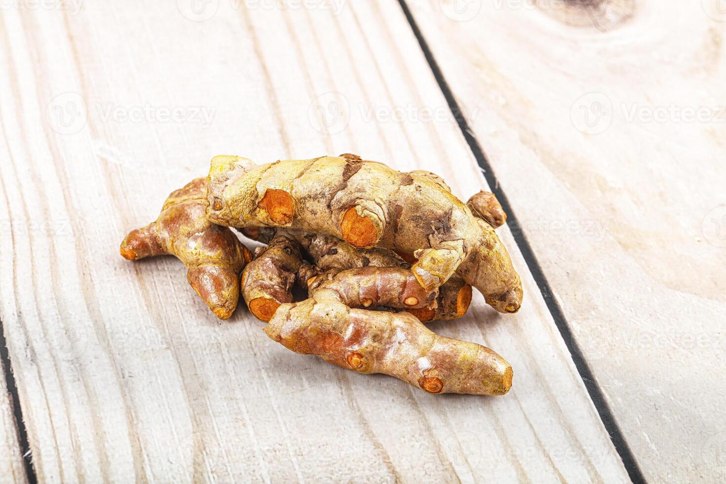 Fresh young Tumeric root heap photo