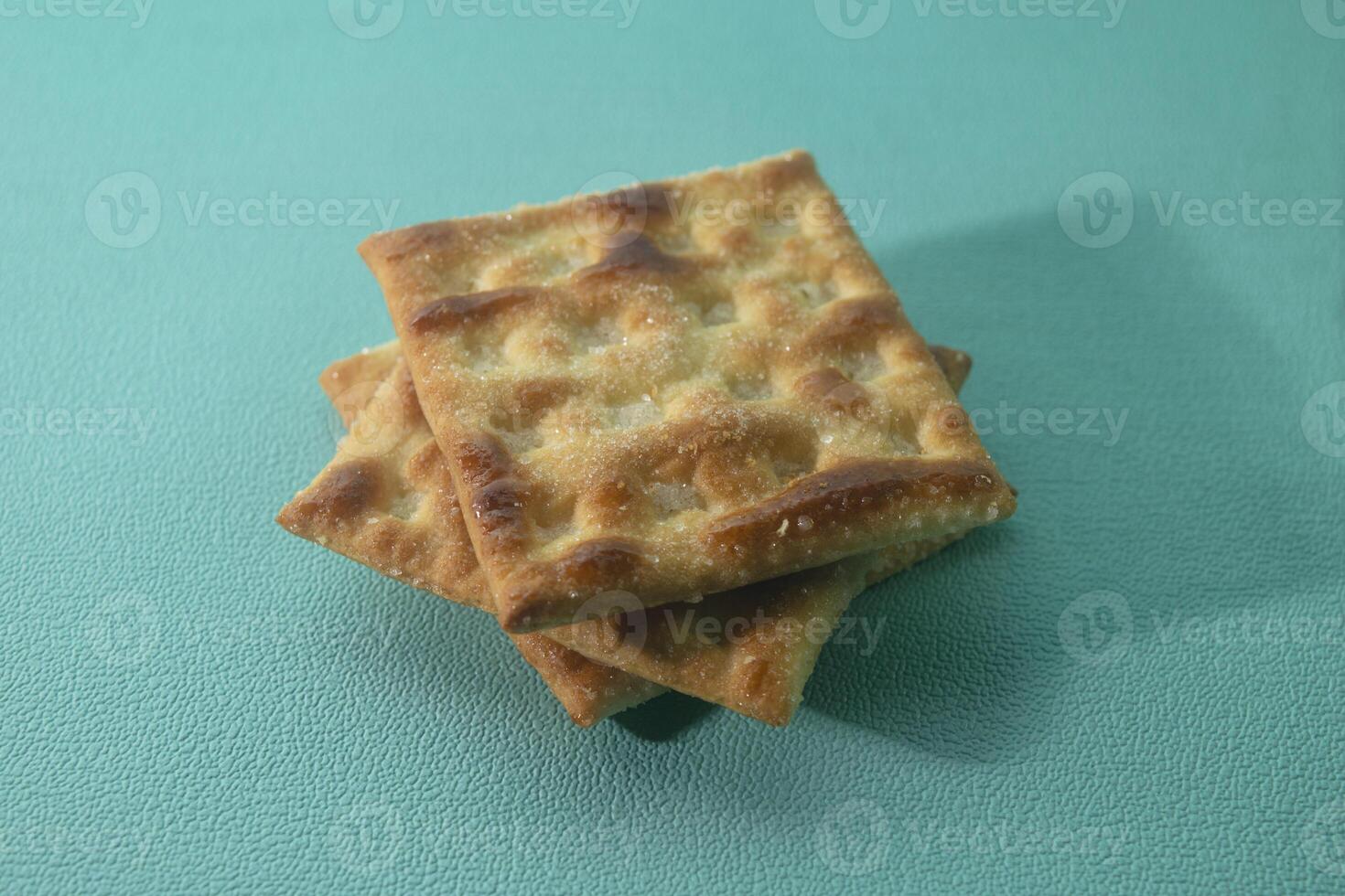 close up of cracker biscuit on green background photo