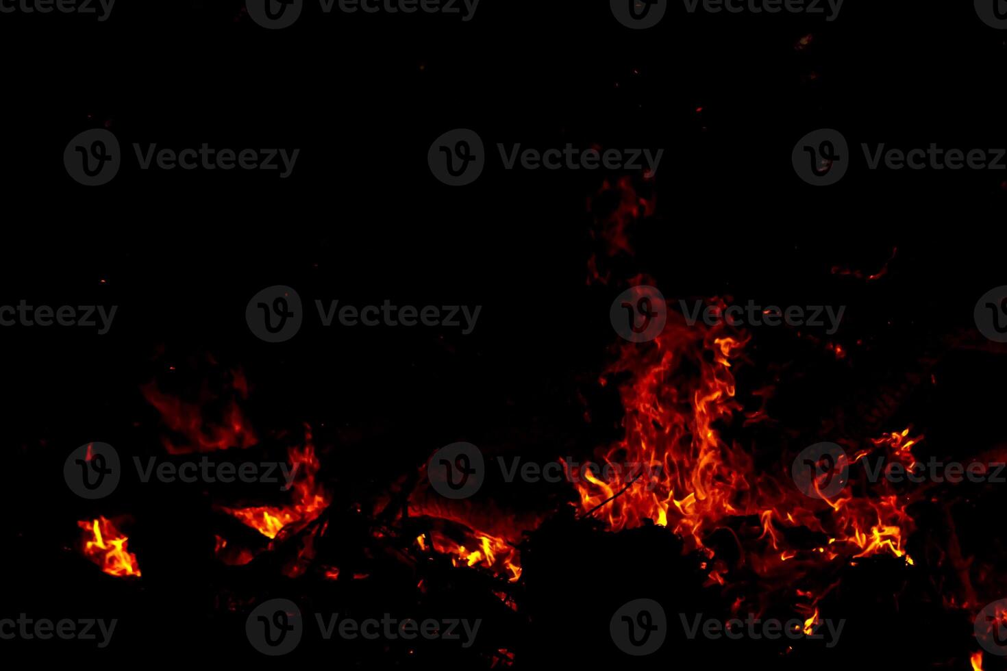 The sparkle of the flames in the dark background. photo