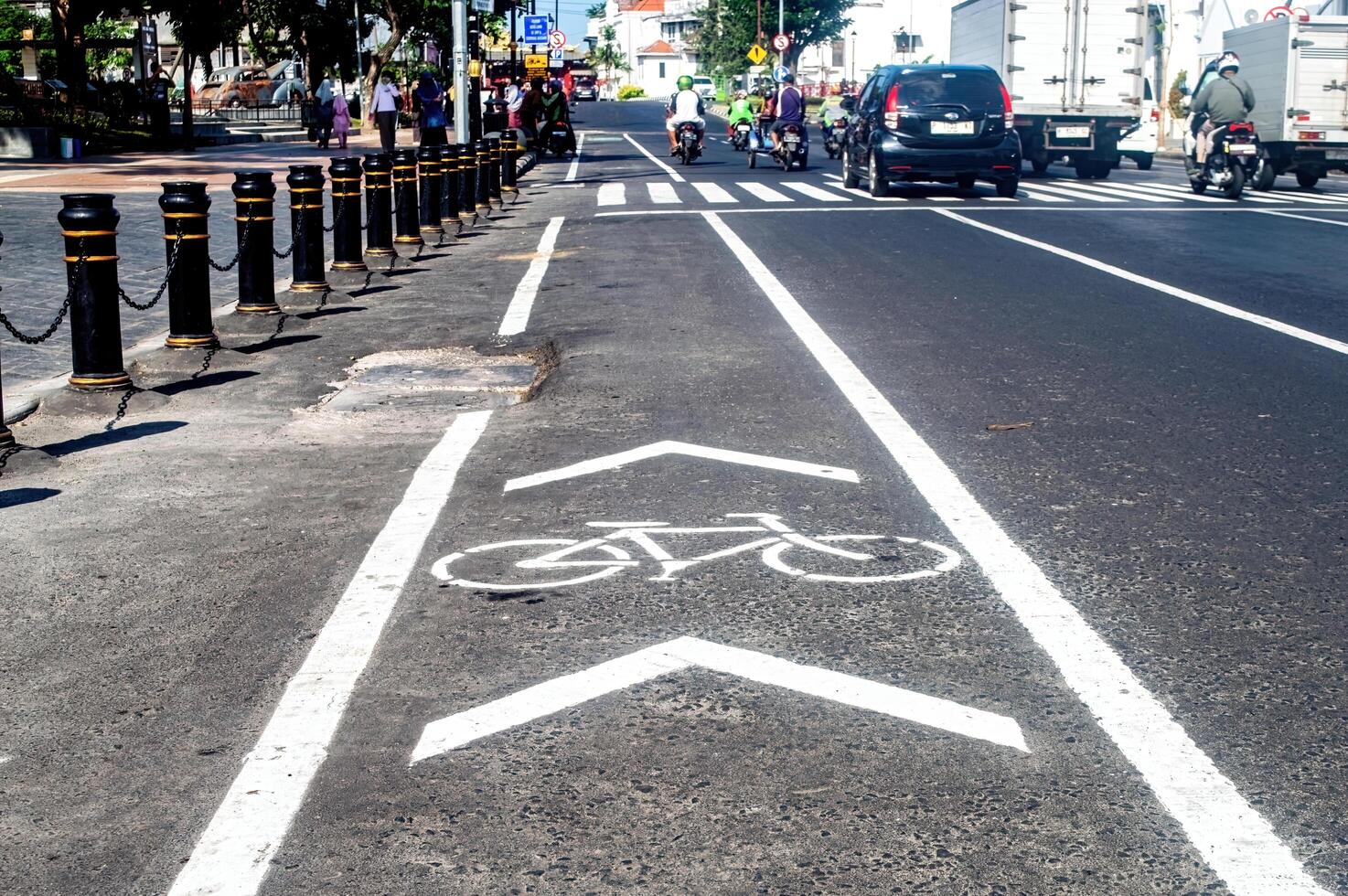 a bicycle way or bike lane on the side of an asphalt road in the city of Surabaya, Indonesia, 20 June 2024. photo