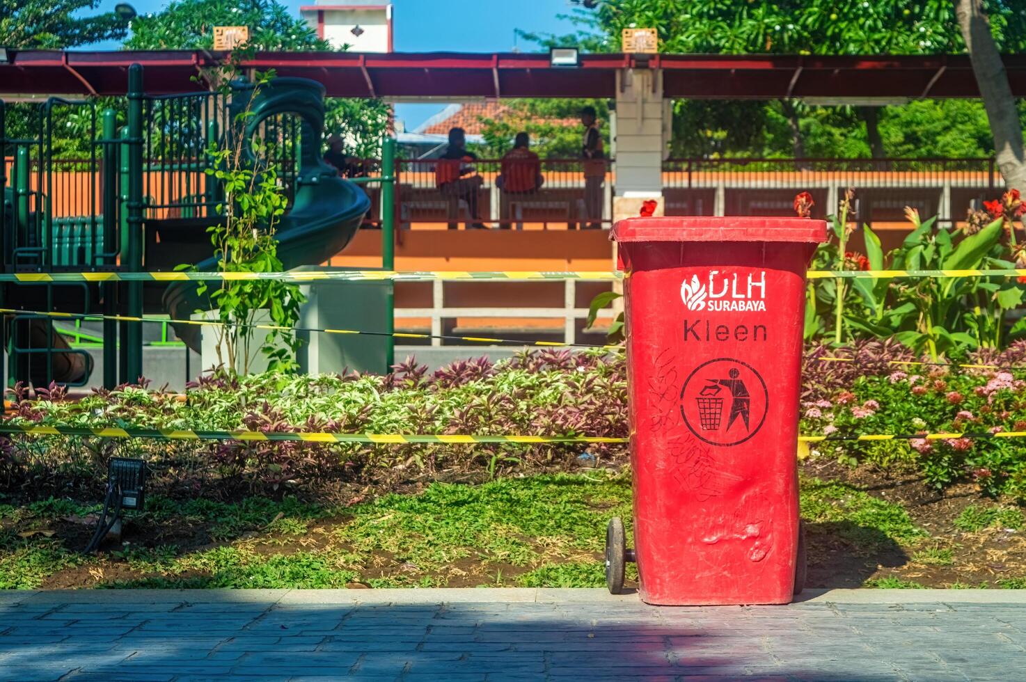 a red trash can in a public park in Surabaya, Indonesia, 20 June 2024. photo