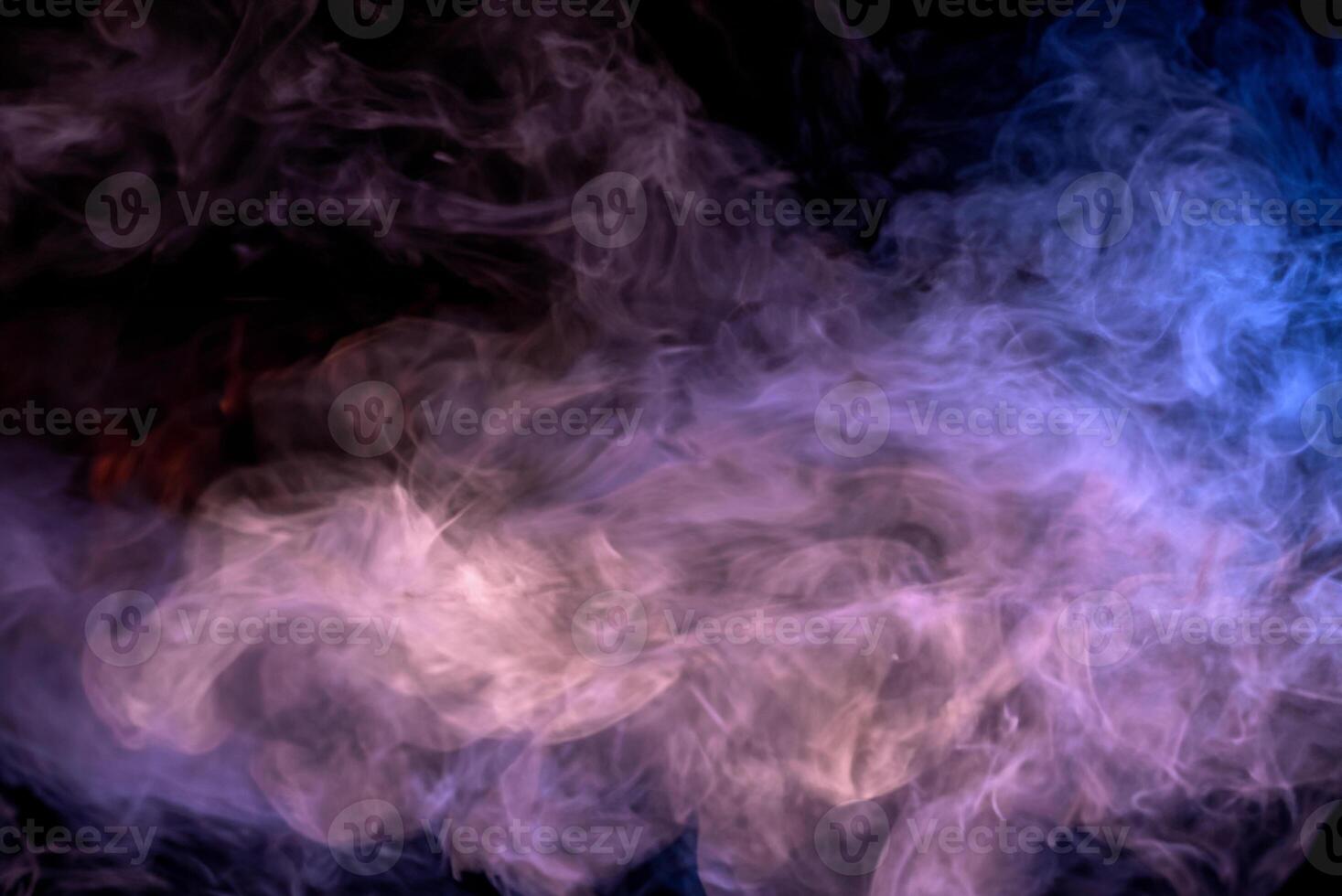 Abstract Multicolored Smoke on Black Background with Wooden Table photo