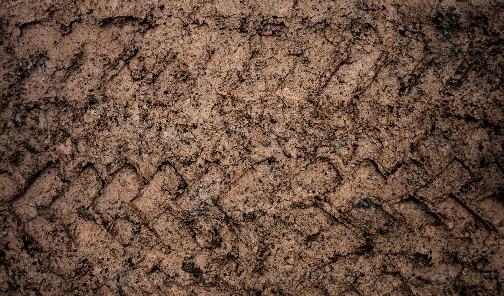 Off-Road Tire Track on Dirt and Grass Field in Retro Grunge Tone photo