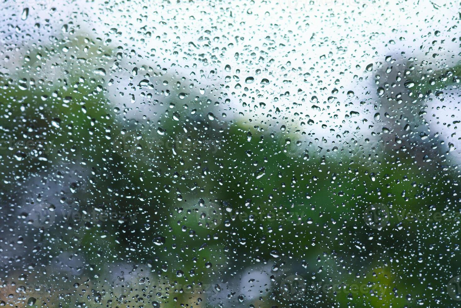 Macro Shot of Raindrop on Windowpane photo