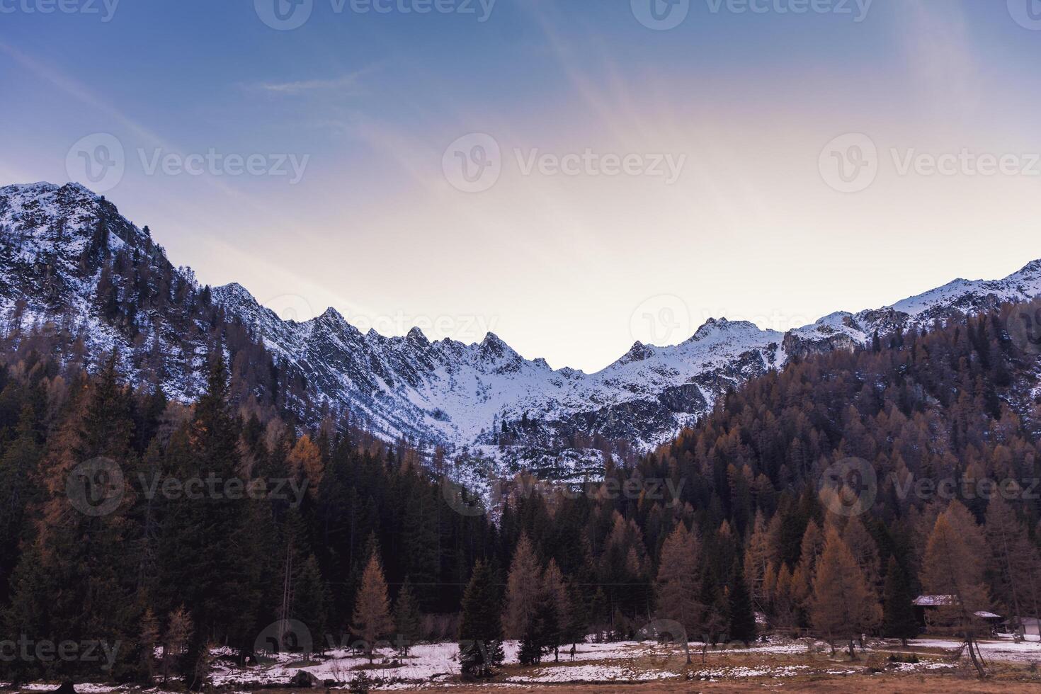 panoramic sunset views of the snowy peaks of the Italian Alps photo