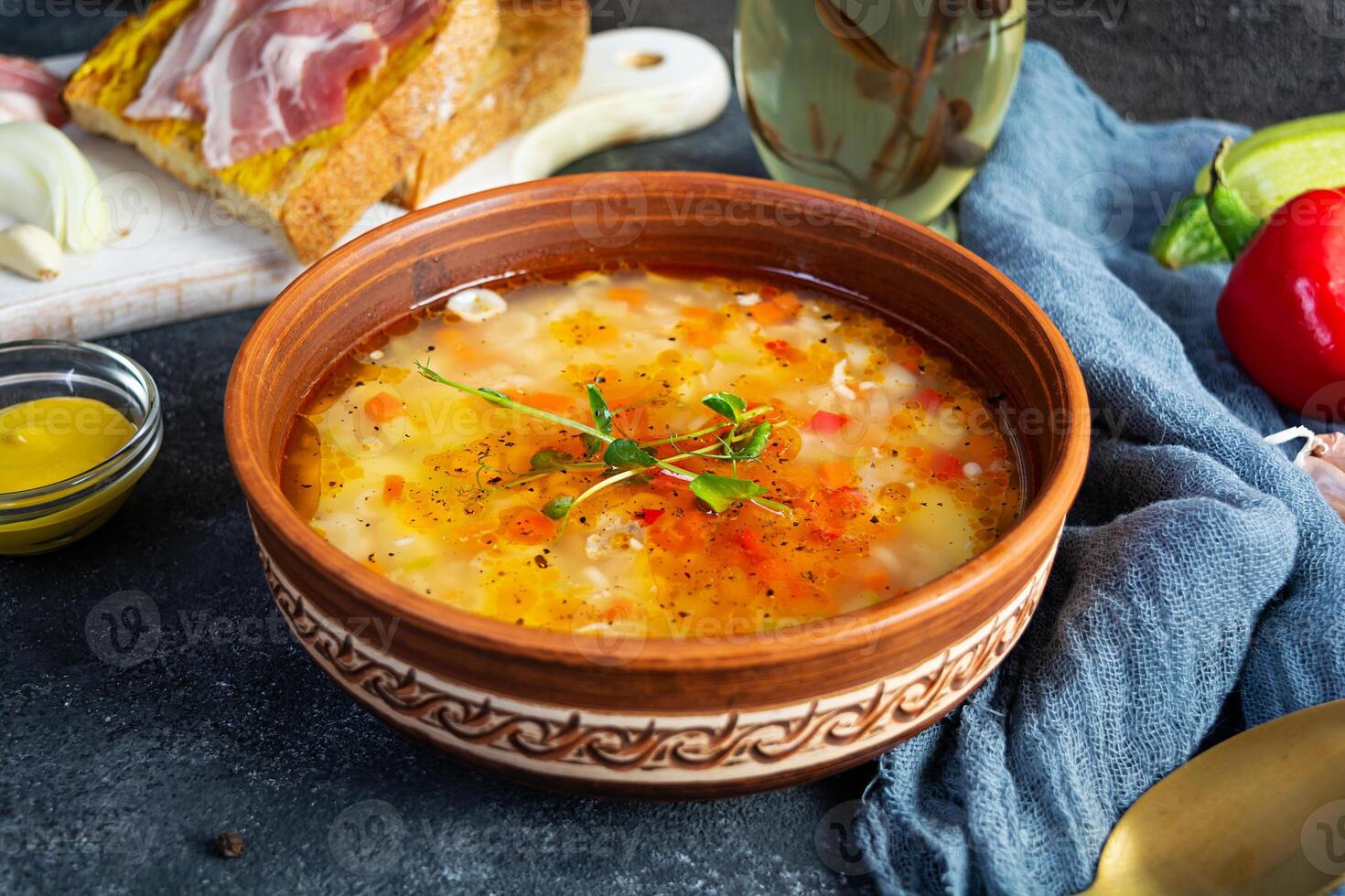 Minestrone soup. Vegetable soup with grilled bread, ham and spices photo