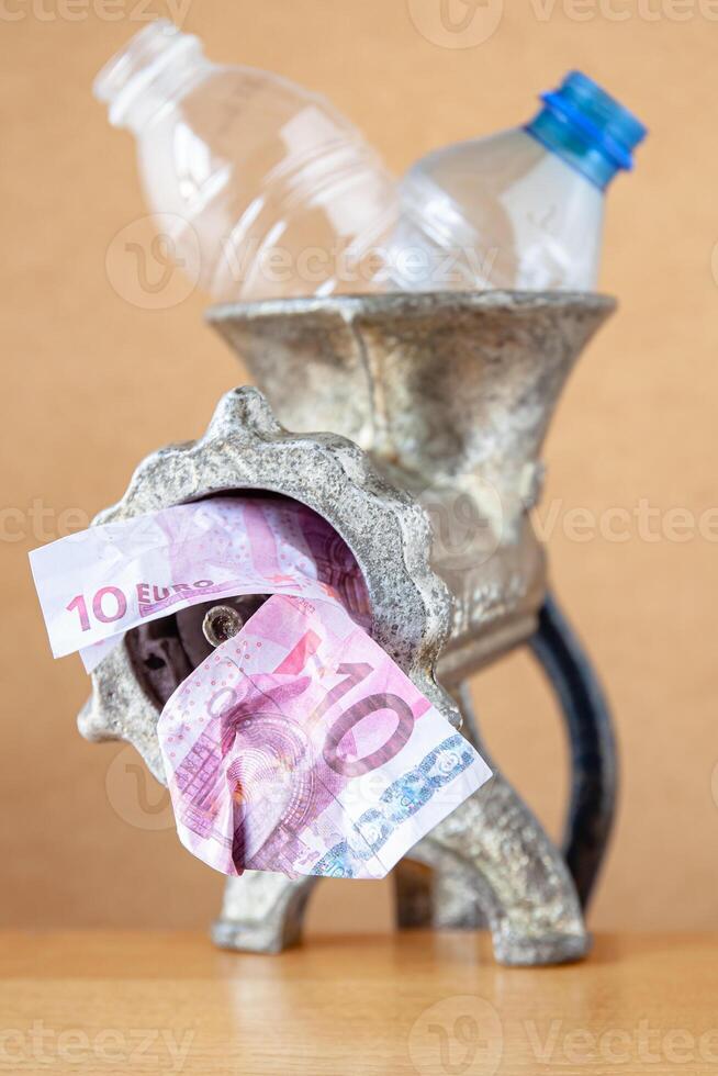 Plastic bottles in a meat grinder for recycling. photo