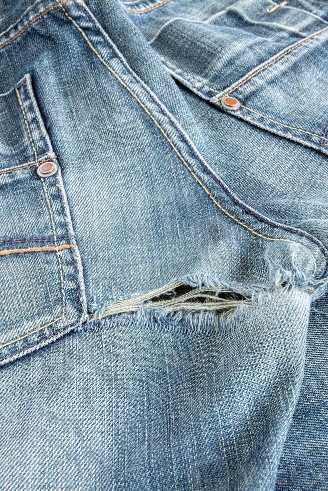 Ripped blue jeans at the back photo