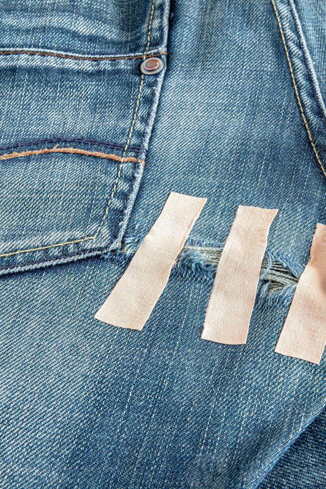 Ripped blue jeans at the back photo