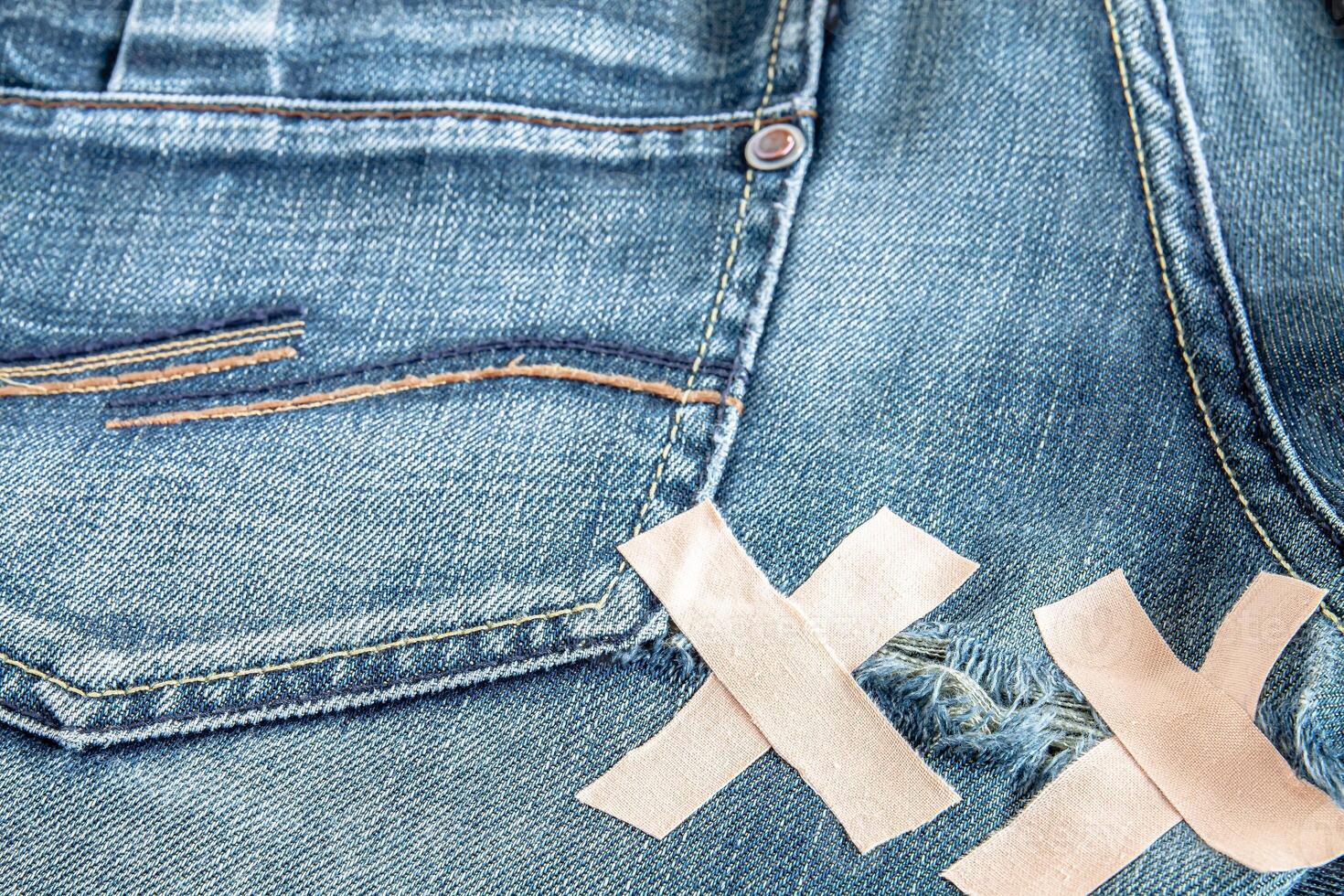 Ripped blue jeans at the back photo