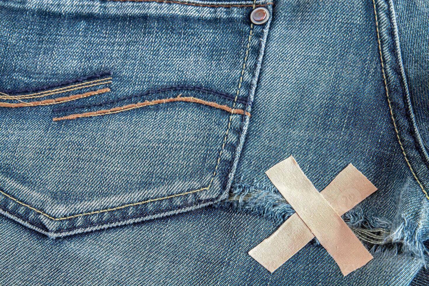 Ripped blue jeans at the back photo