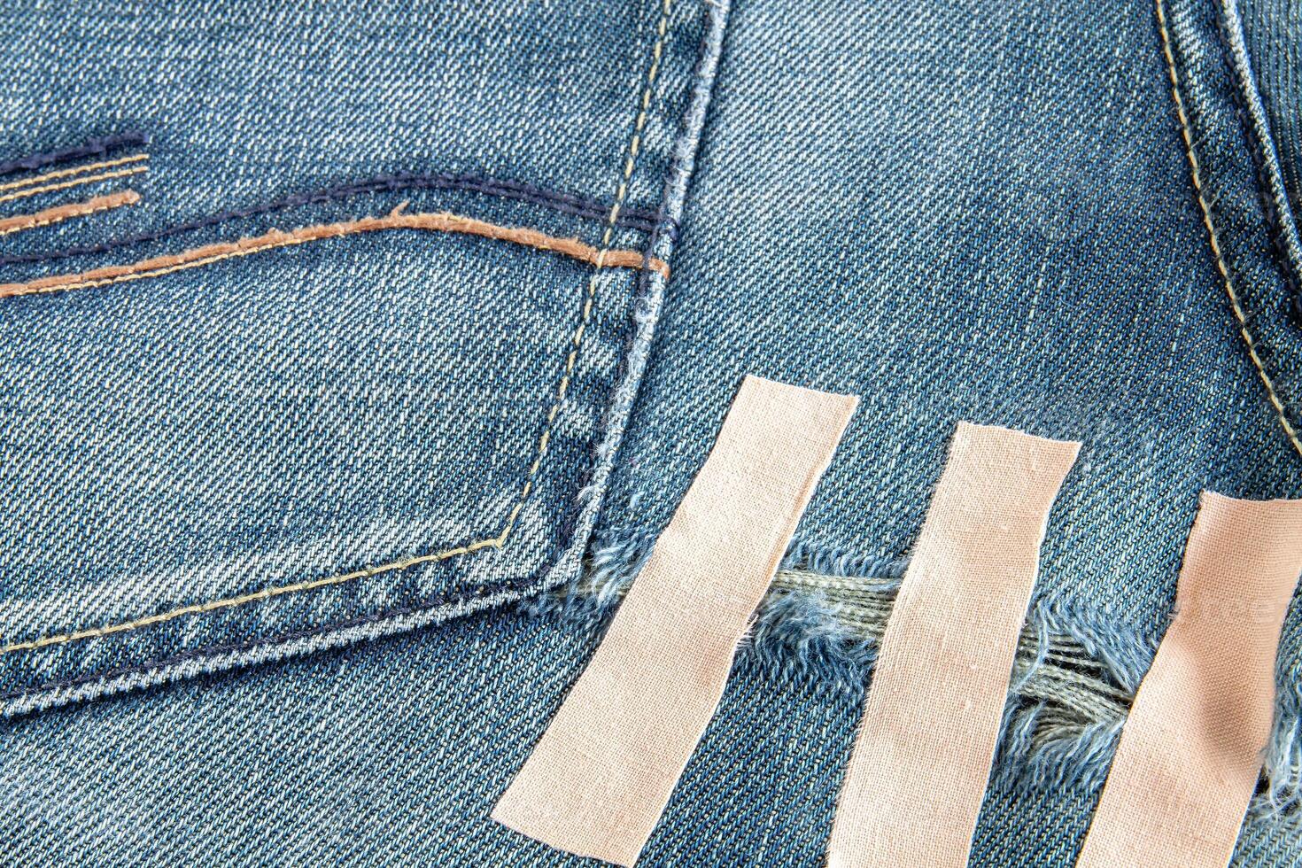 Ripped blue jeans at the back photo