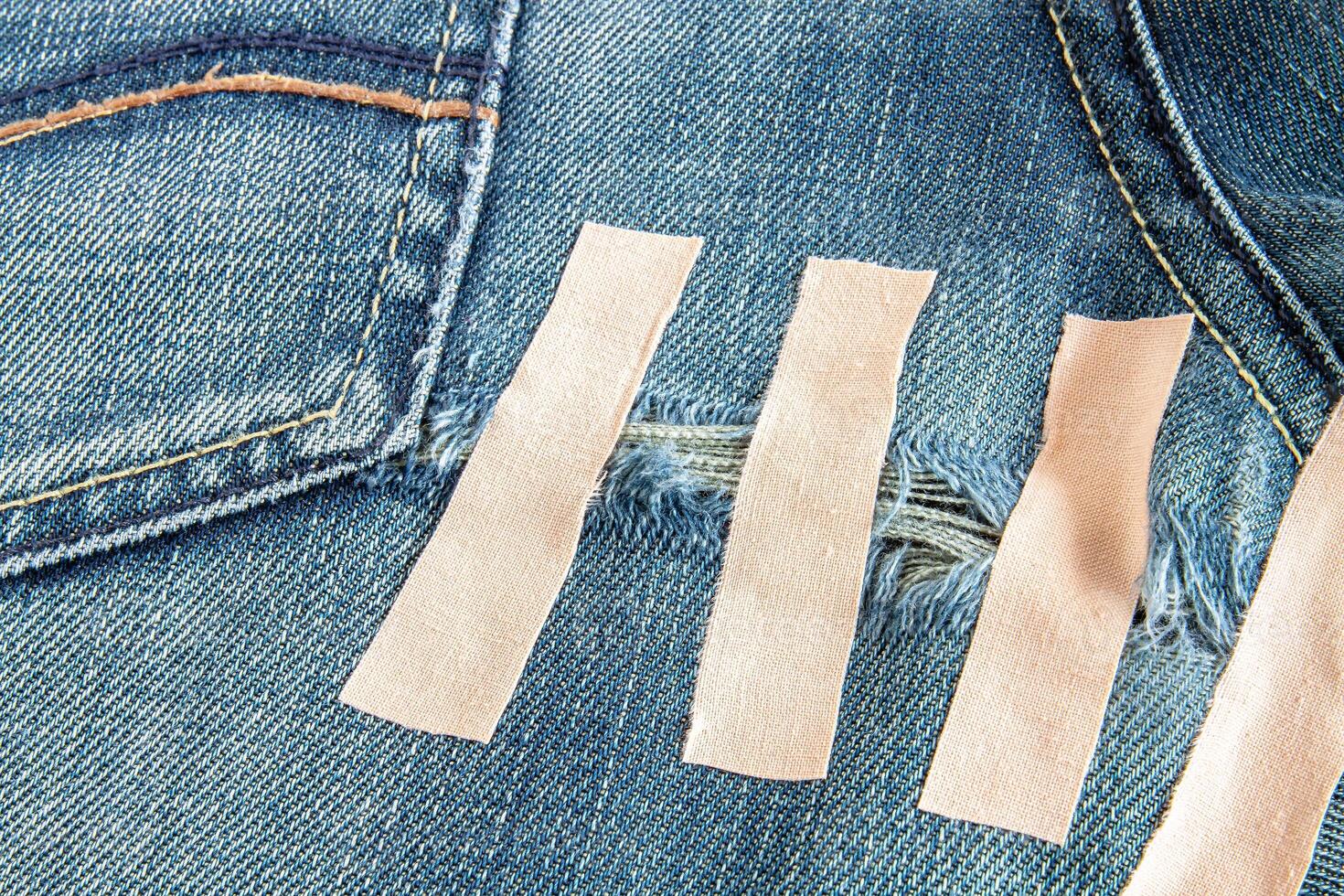 Ripped blue jeans at the back photo