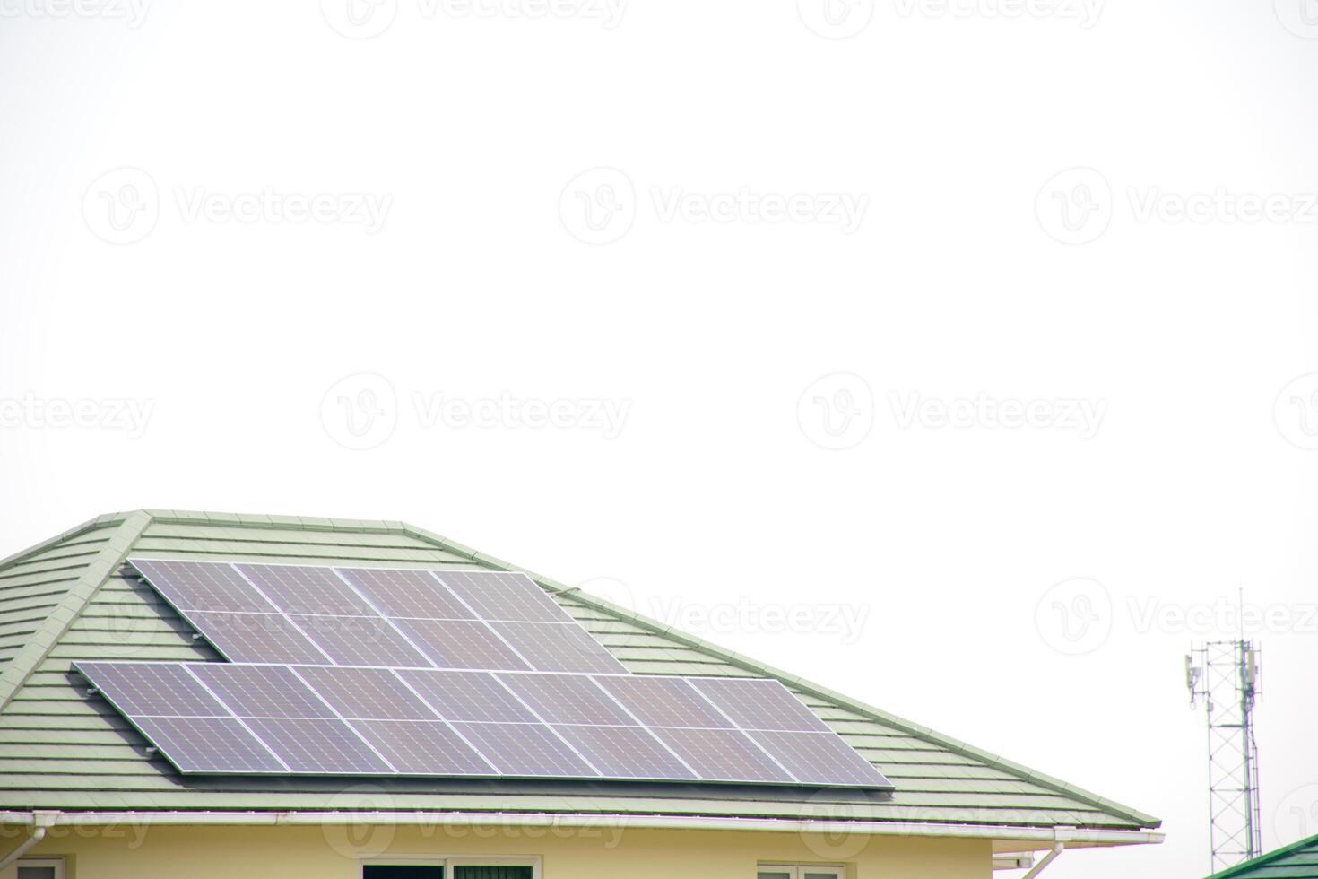 Installing a solar cell on a roof. Solar panels on roof. Modern house with modern solar panels on tile roof and wall against clear sky background 2025. photo