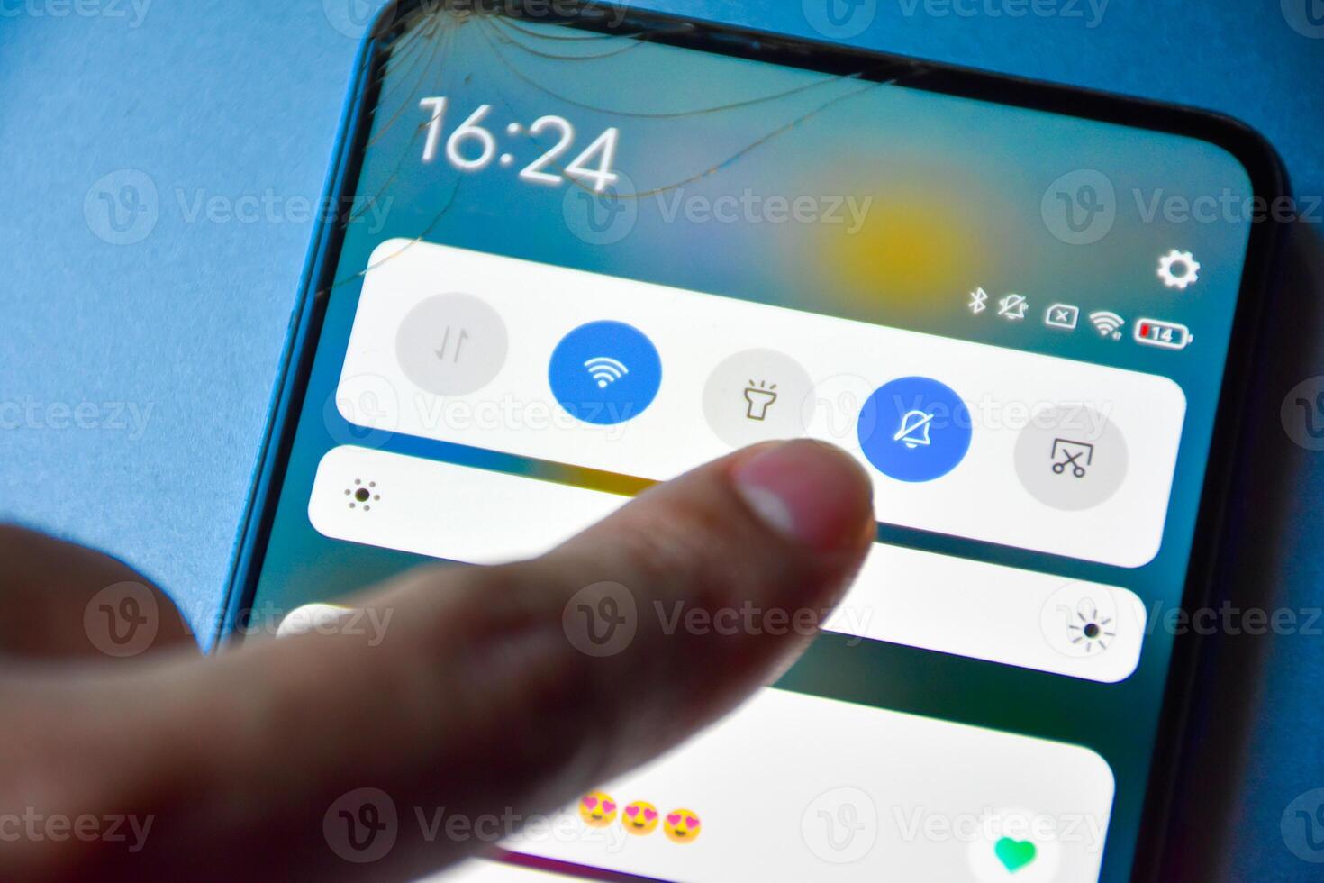 Finger pressing to turn off notification mode on Android mobile phone display screen and notification of matches in dating applications, Finger presses off the interference button. photo