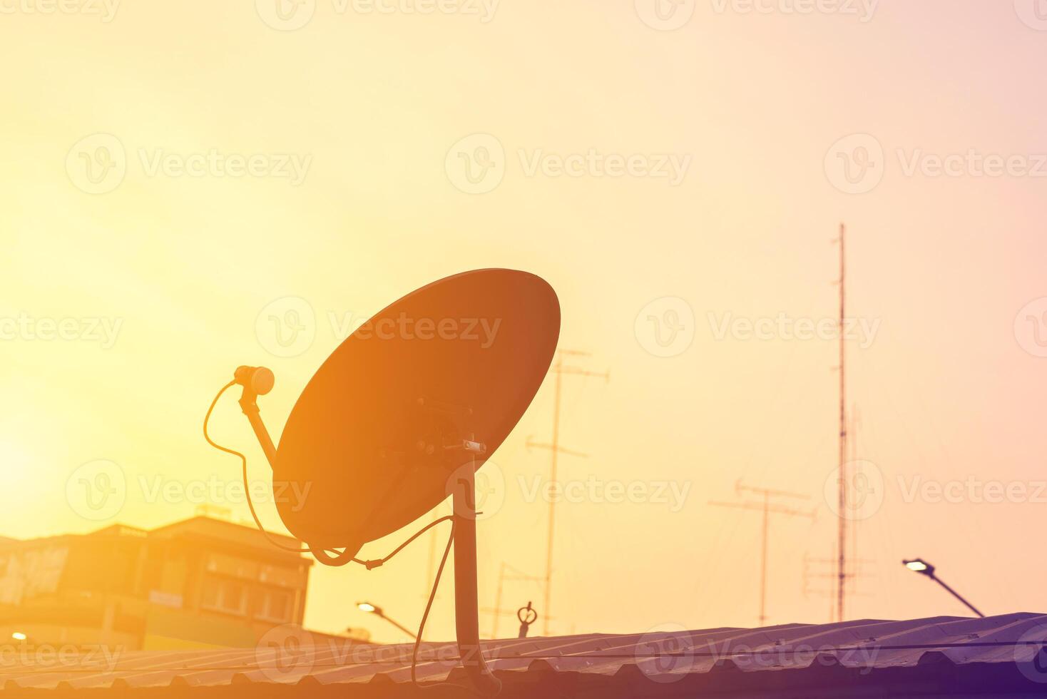 Satellite dish antenna on top of the house photo
