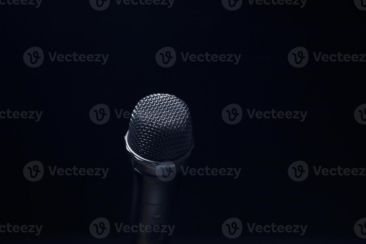 Black and silver microphones in the studio on a black and dark background. Professional recording equipment. Top view. photo