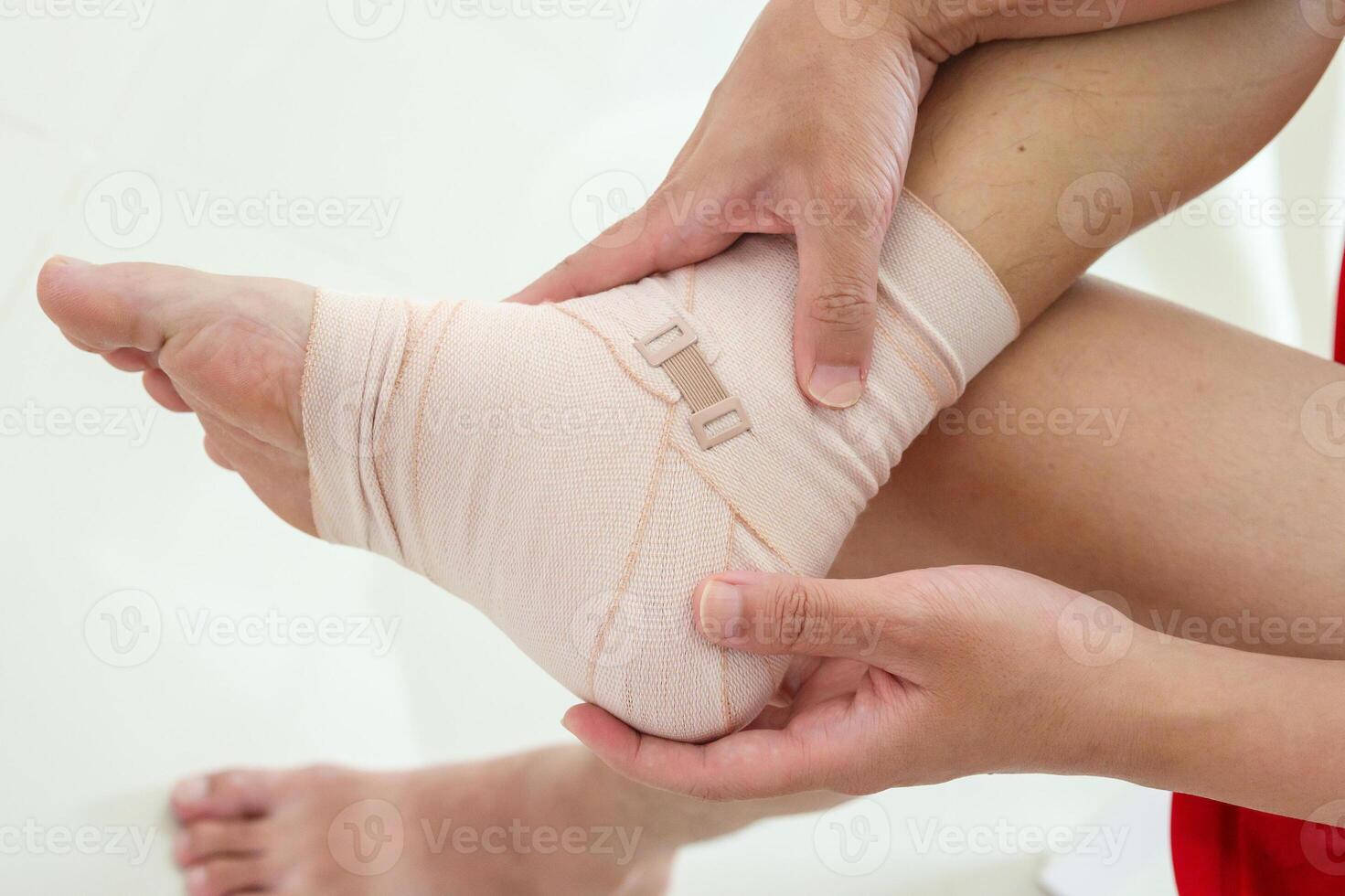Man with ankle sprain elastic bandage for ankle injury and feeling pain photo
