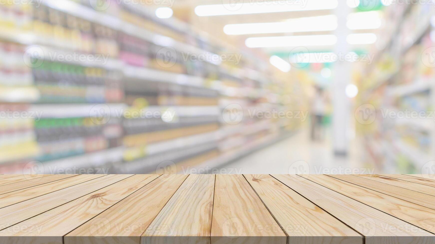 Empty wood table top with supermarket blurred background for product display photo