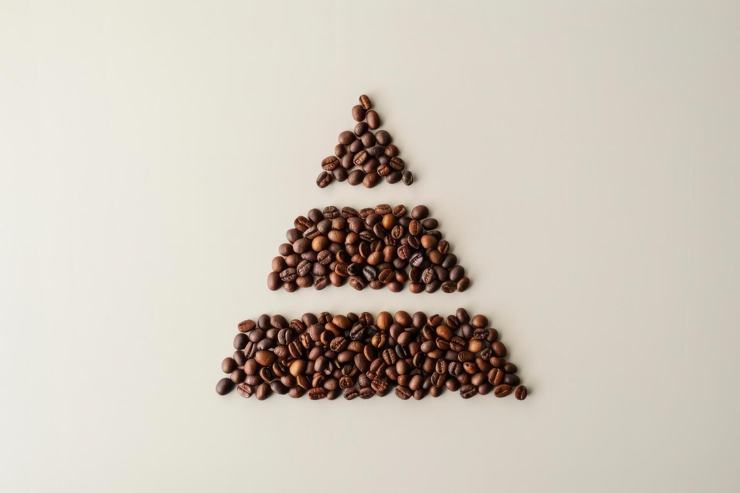 Pyramid of coffee beans divided into four parts, horizontal division, top view, flat light background. photo
