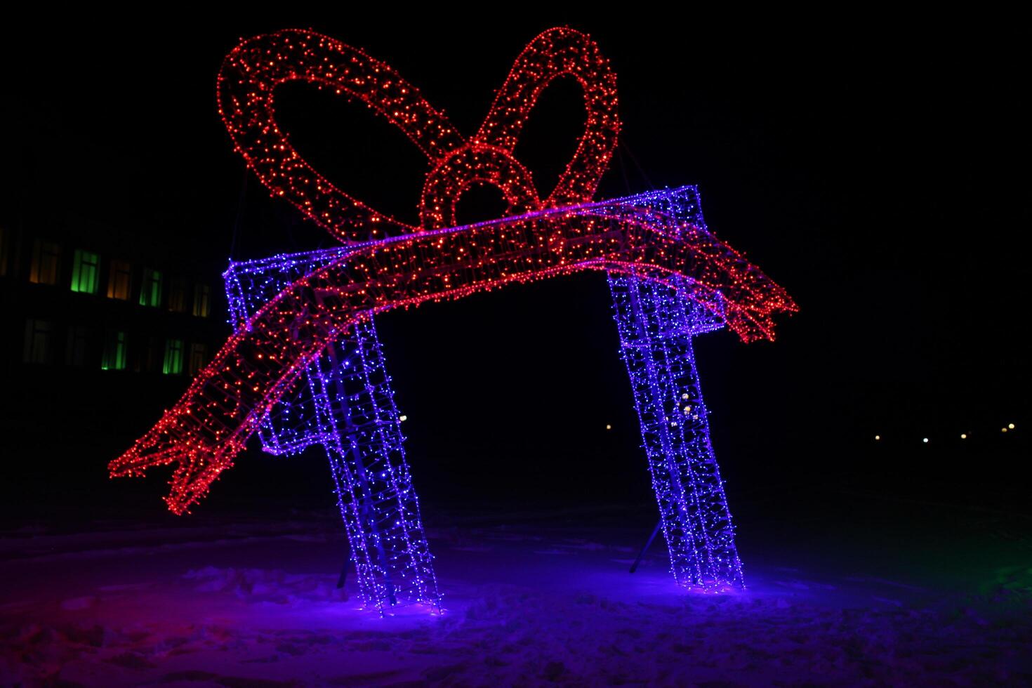 Christmas neon gift figure in blue and red color. Outdoor Decorations photo