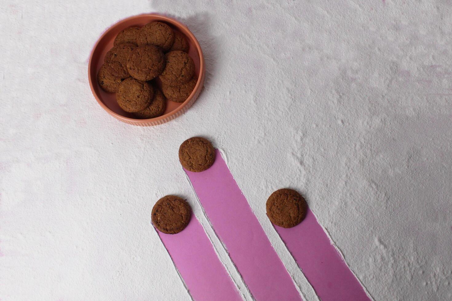The concept of fertilization of an egg with sperm. Three cookies are aiming for a plate of oatmeal multigrain cookies photo