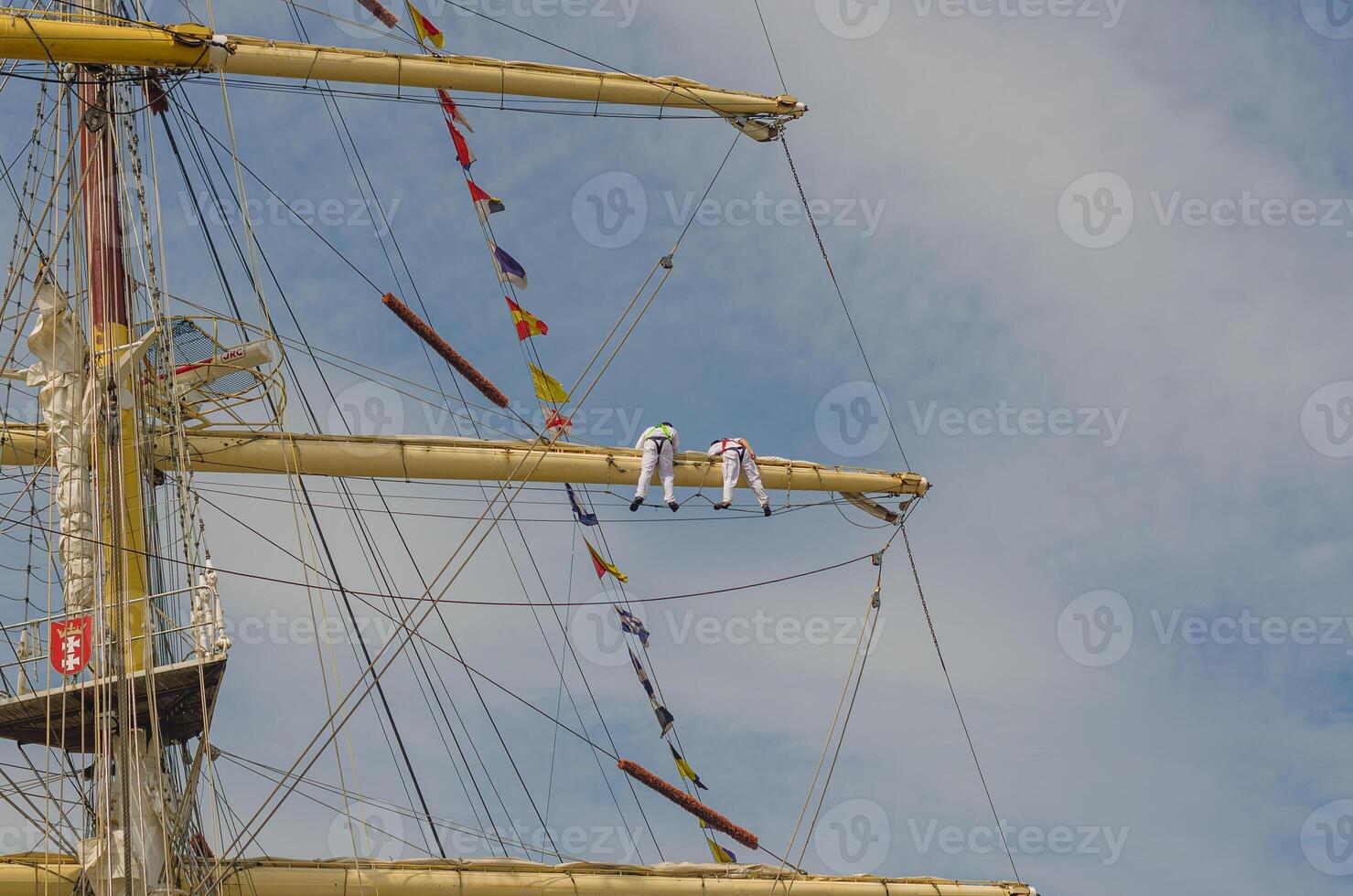 Masts and rigging of a sailing ship against blue sky and clouds. High quality photo