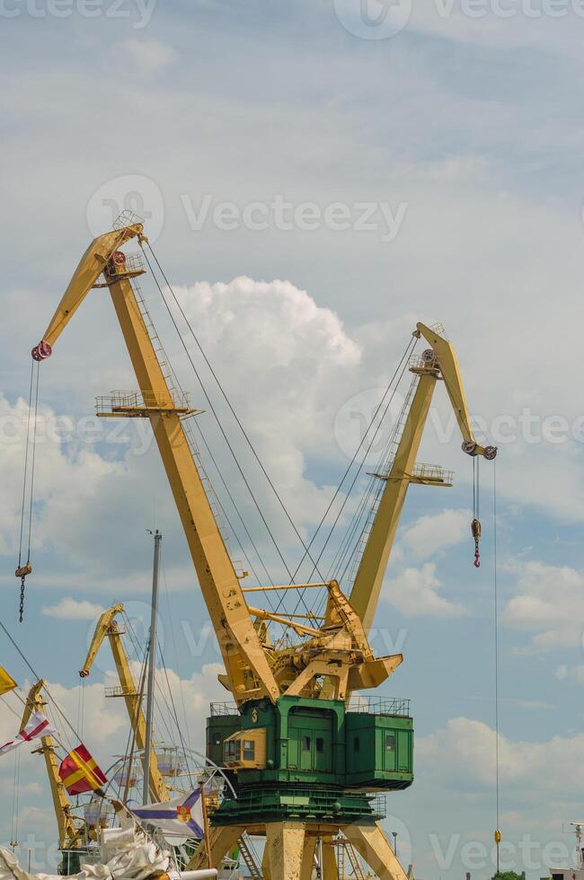 Working port cranes. Unloading and loading of goods at the port. High quality photo