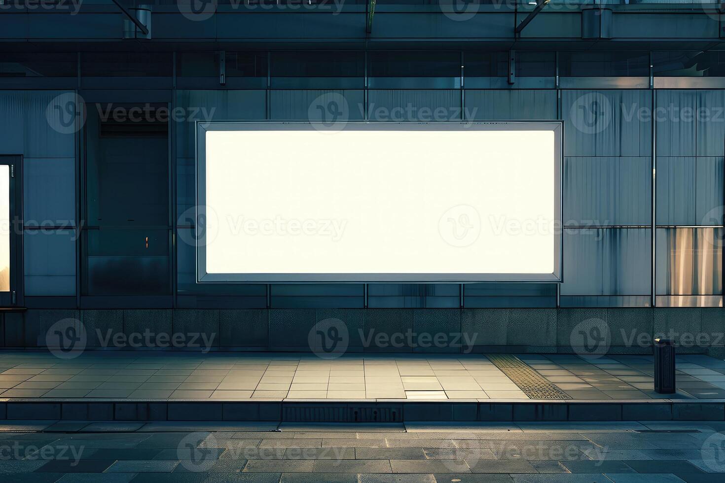An empty billboard on a building exterior for mockup advertisement, at dusk with a lit interior backdrop photo
